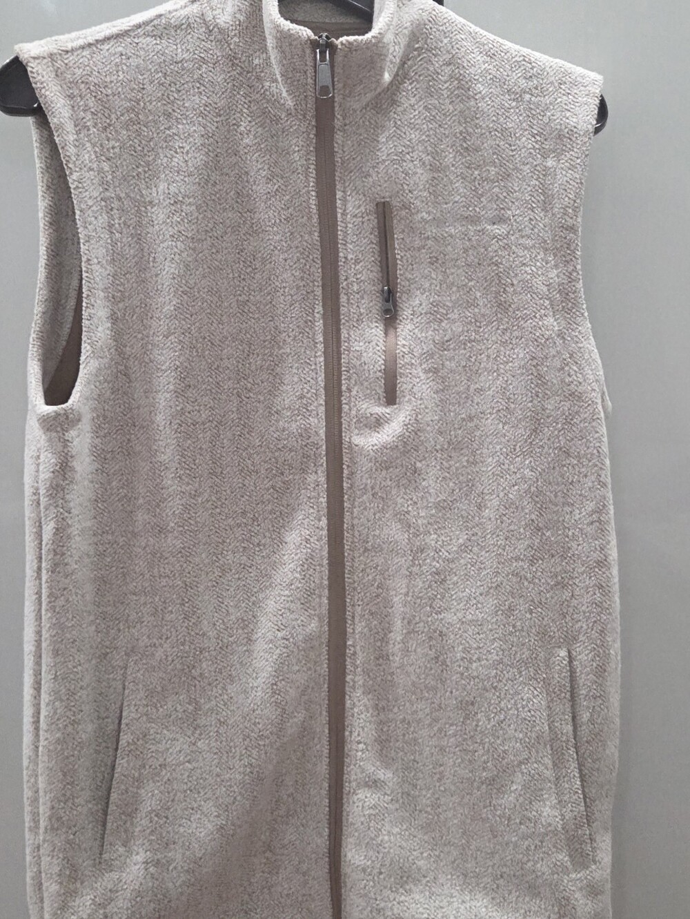 heather full-zip sweater fleece vest featuring a stand collar and vertical zip..